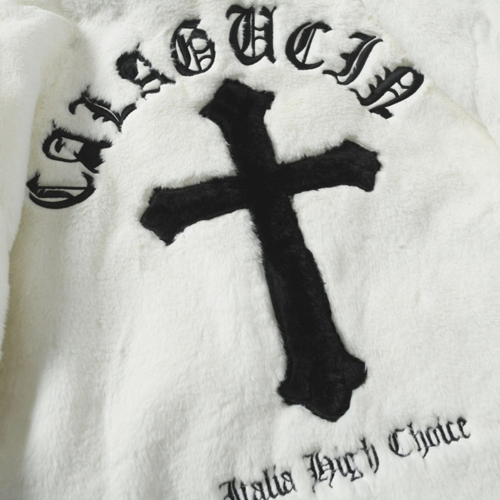 Black cross and text on a white blanket