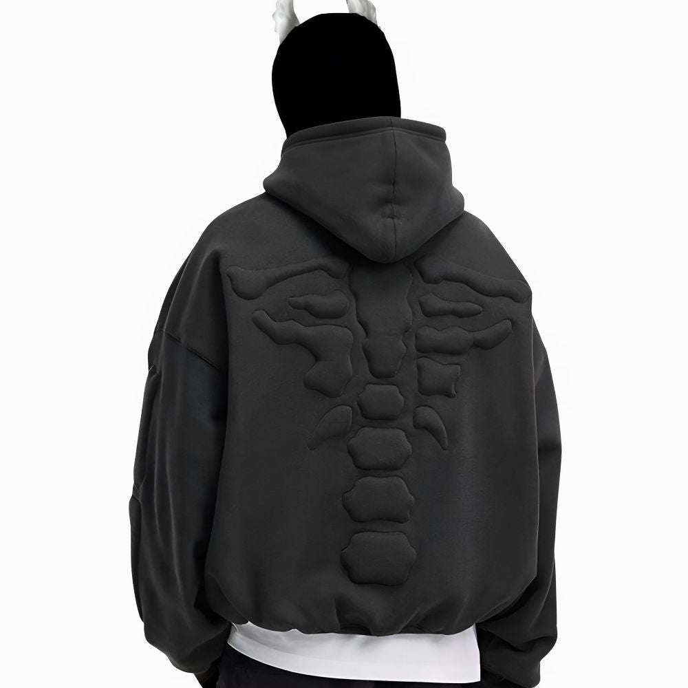 Black hoodie with scorpion design on the back worn by a person against a white background