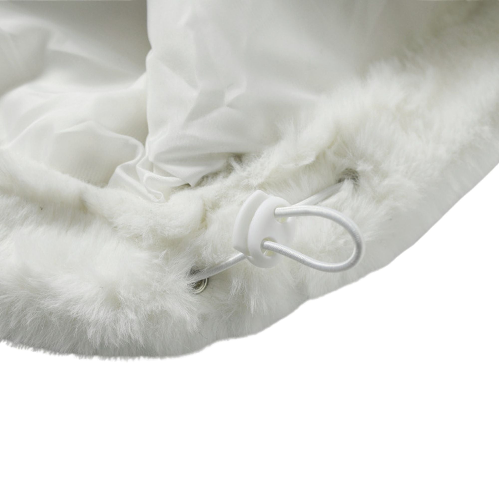 Close-up of a fluffy white blanket with a hook on a white background