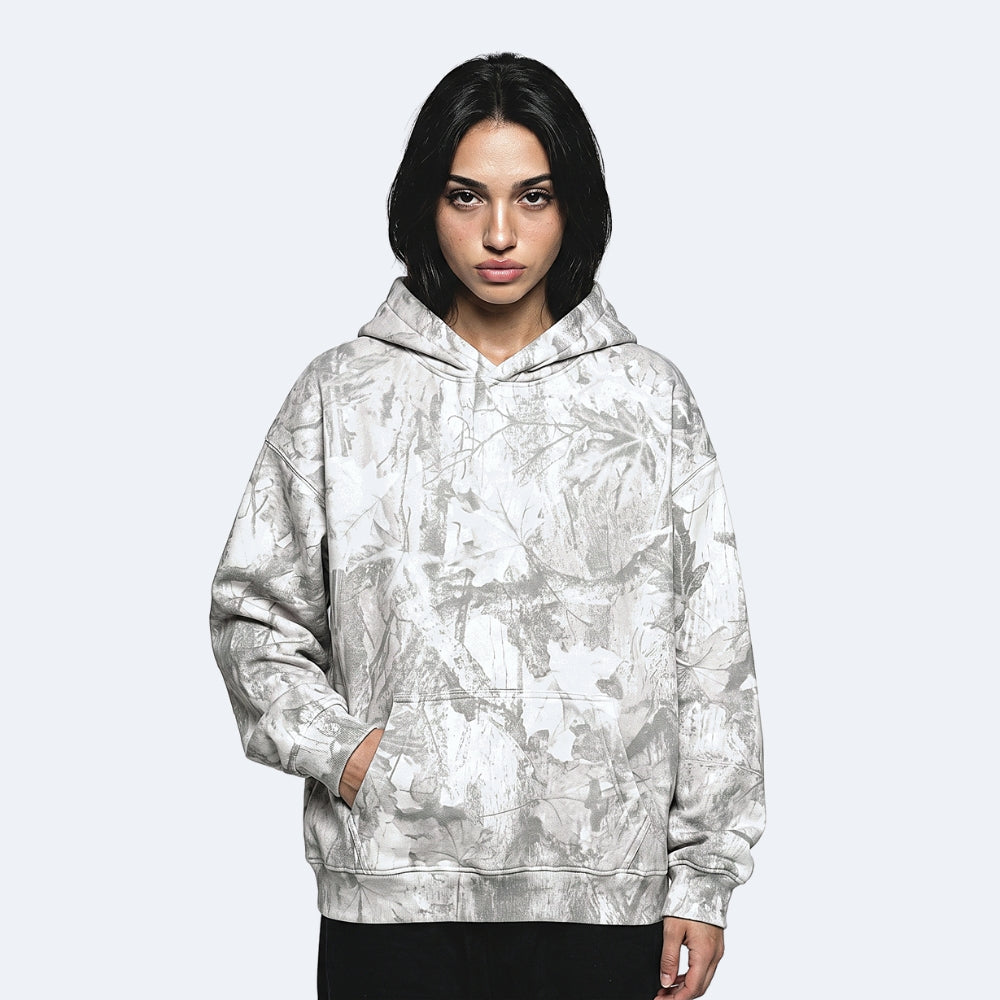 Frost. A model with short black hair wearing a light gray and white abstract patterned hoodie.