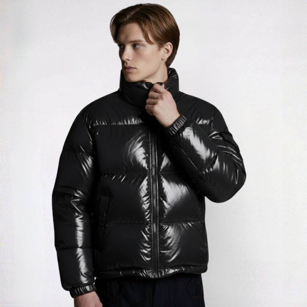 Man wearing a black puffer jacket on a white background