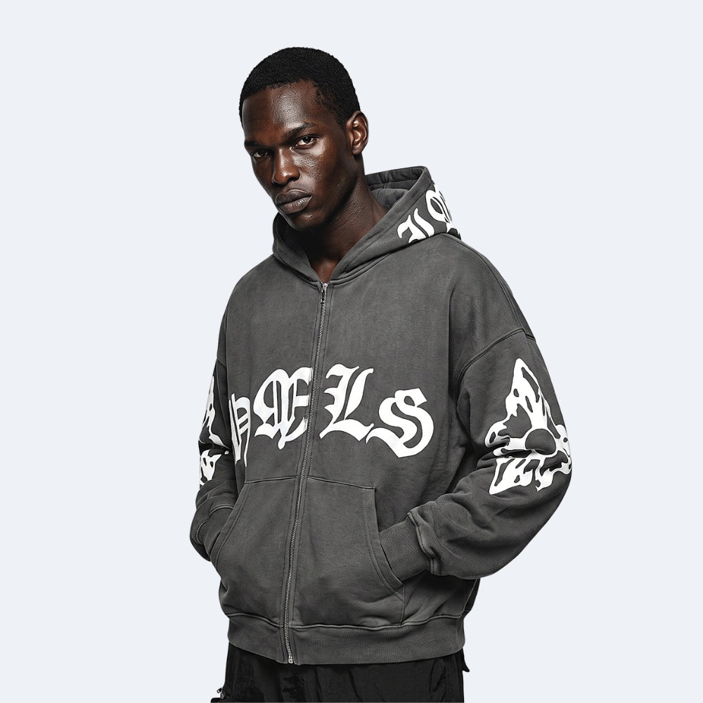 Gray. A man wearing a dark gray zip-up hoodie with white Gothic lettering on the front and sleeves.