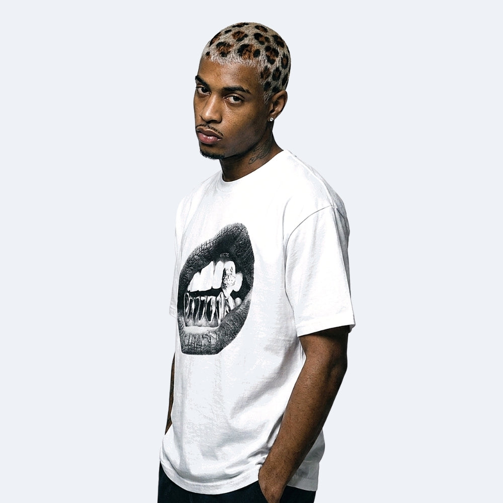 White. A man wearing a white crewneck t-shirt with a black graphic of a mouth showing teeth.