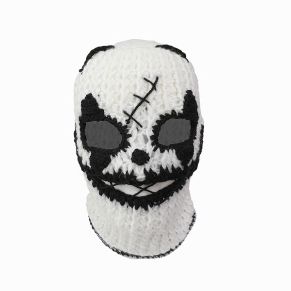 White knitted mask with black accents on a white background