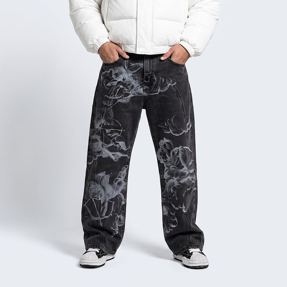 Black. A person wearing loose black denim jeans with a gray and white floral print, paired with a white puffer jacket and white sneakers, shown from the chest down.