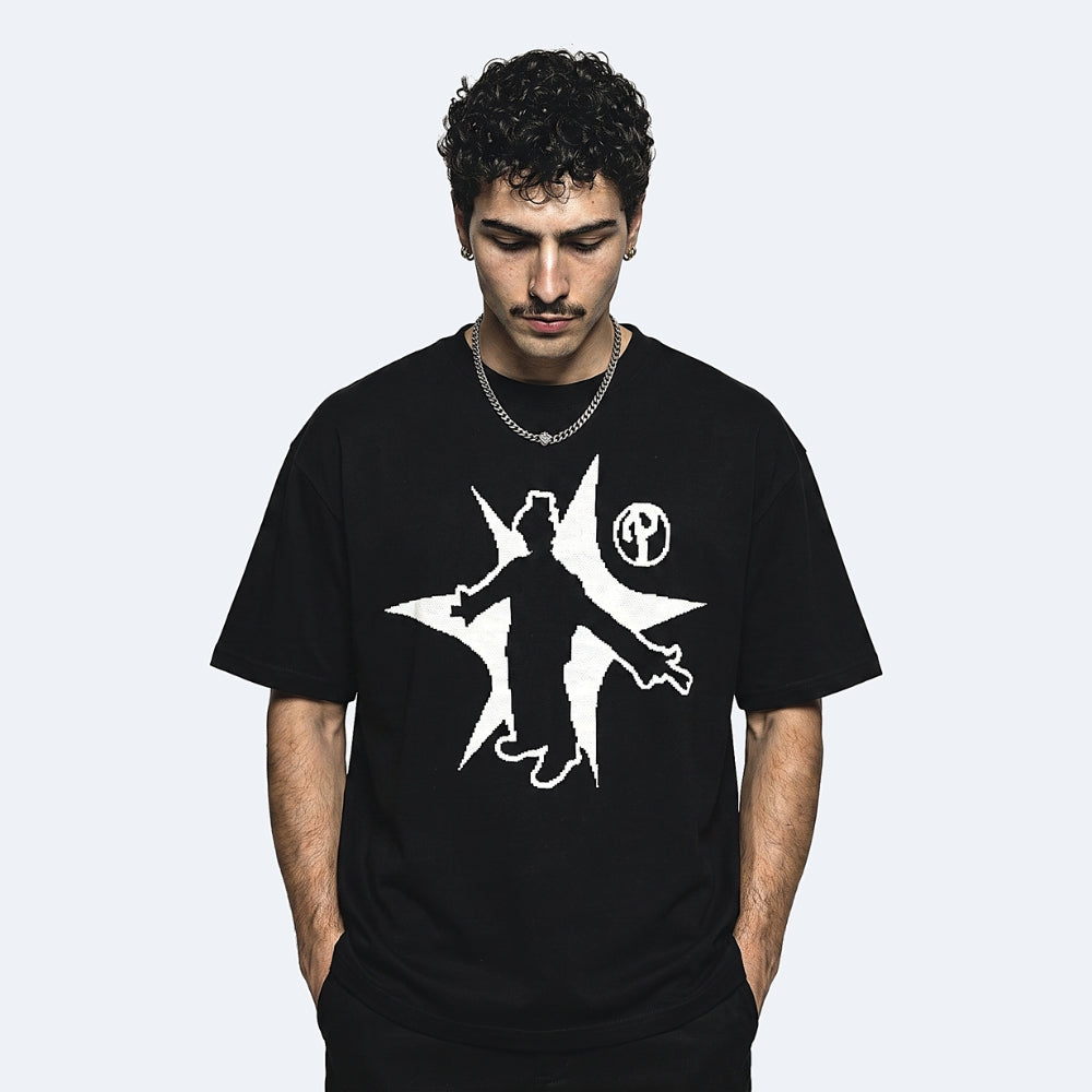 Black. A man wearing a black crewneck t-shirt with a white graphic print of a silhouette figure inside a star.
