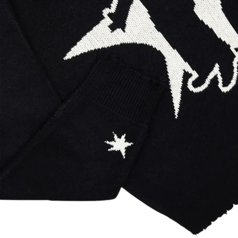Black sweater with white star design on a white background