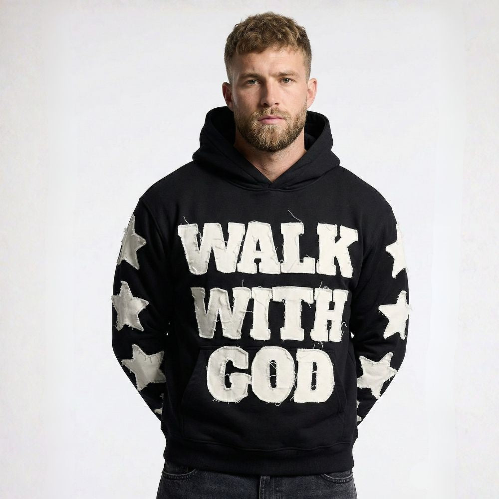 Man wearing a black hoodie with 'Walk With God' text on a white background