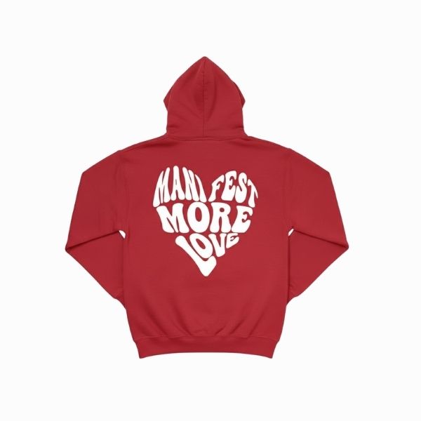 Red hoodie with 'Manifest More Love' text on a white background