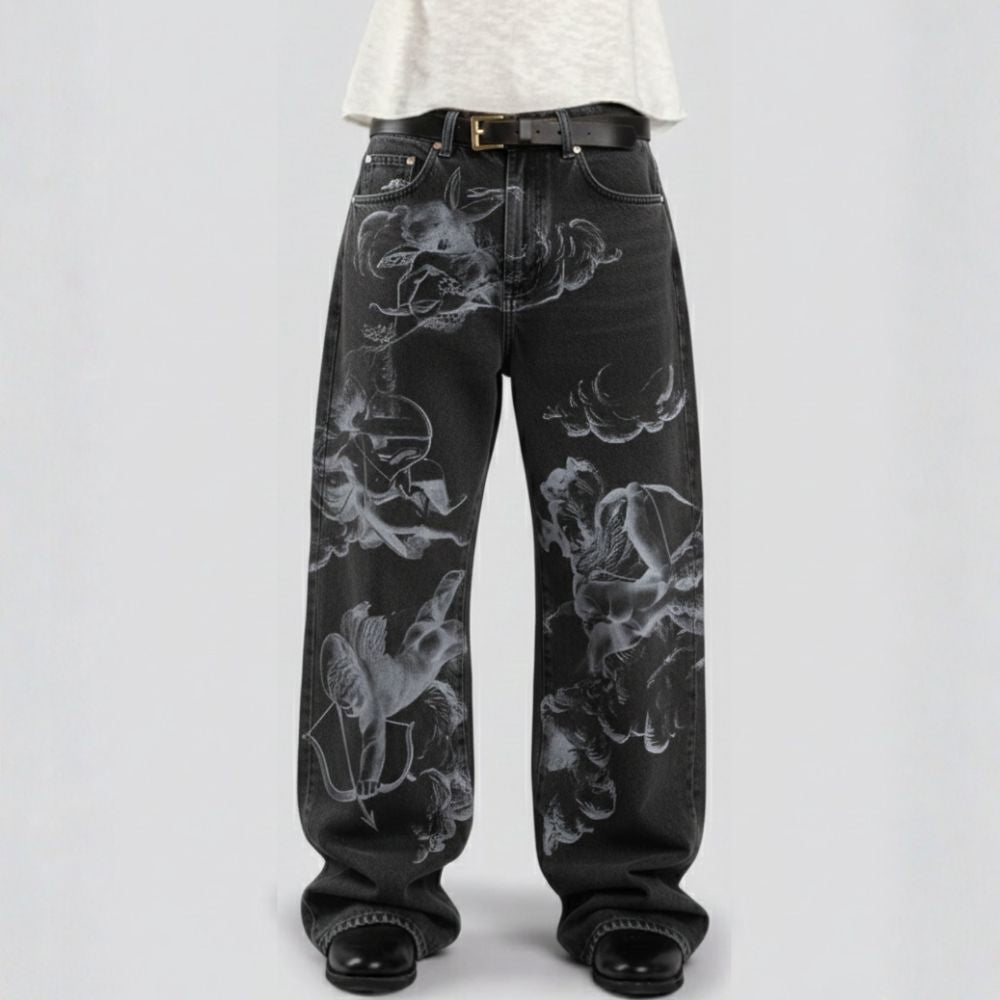Black jeans with white floral patterns worn by a person on a light gray background