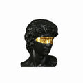 Black classical bust with gold eye on a white background