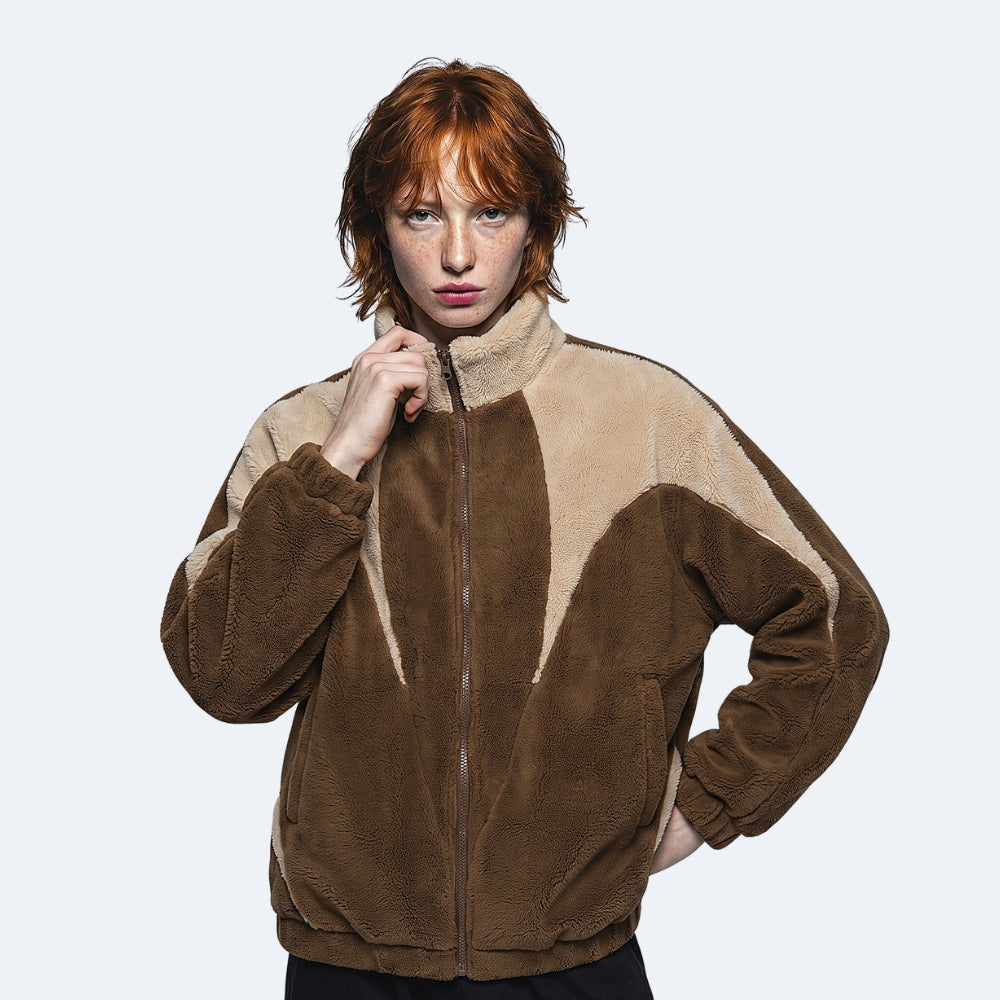 Brown. A model with red hair wearing a brown and beige color-blocked fleece jacket.
