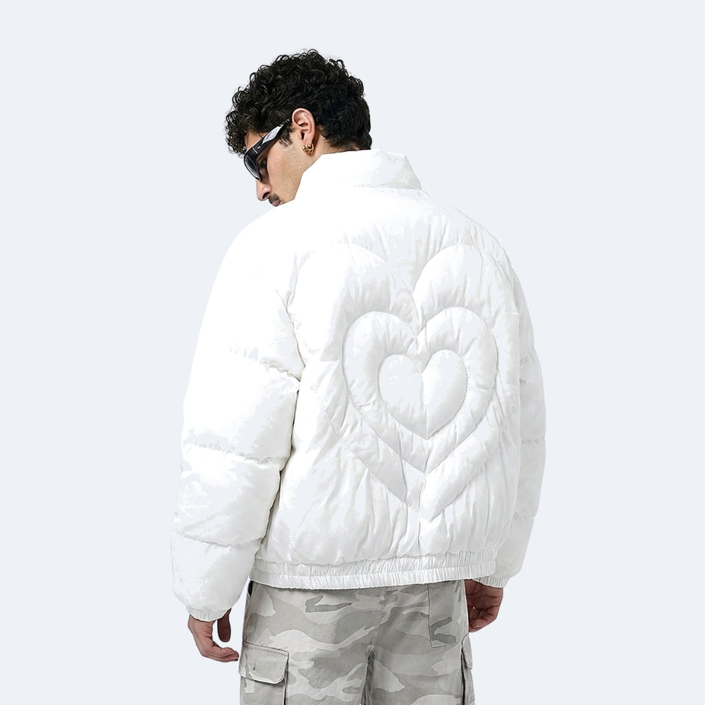 White. A man wearing a white puffer jacket with a large quilted heart design on the back, shown from behind.