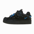Black sneaker with blue accents on a white background