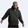 Black. KRUX Feral leopard zip hoodie in black, worn by a male model — front view, oversized fit