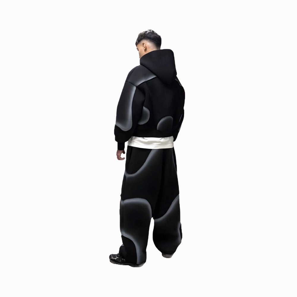 Person wearing a black and gray hoodie with a white belt on a white background