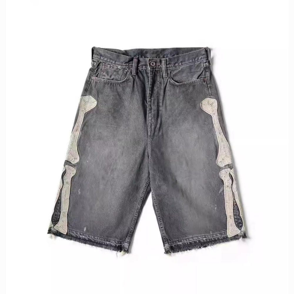 Gray denim shorts with bone designs on a white background