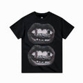 Black t-shirt with graphic of lips and teeth on a white background