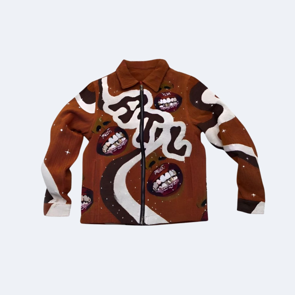 A brown zip-up jacket with a white and black abstract graphic print and repeated grills with gold chains, shown against a light gray background.
