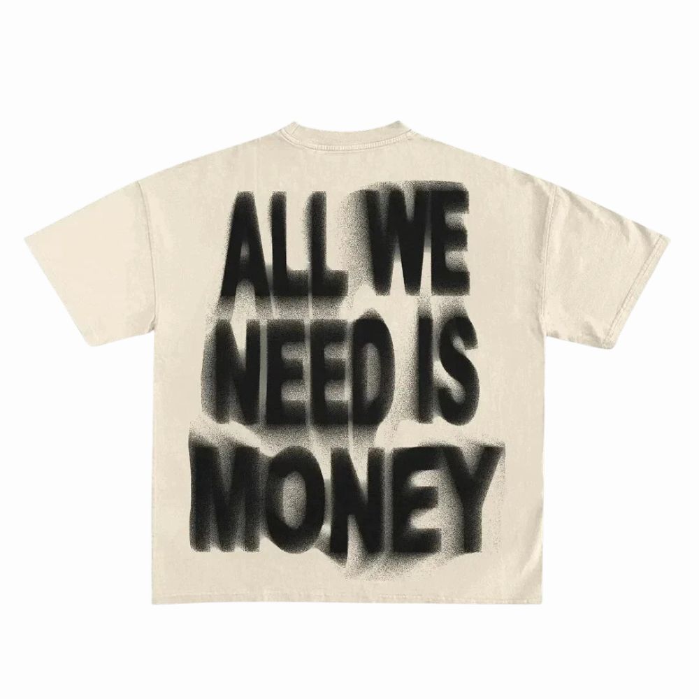 Beige t-shirt with black spray-paint text 'ALL WE NEED IS MONEY' on a white background