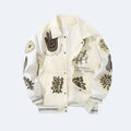 White. An off-white bomber jacket with various graphic patches, embroidered designs, and text on the front and sleeves.