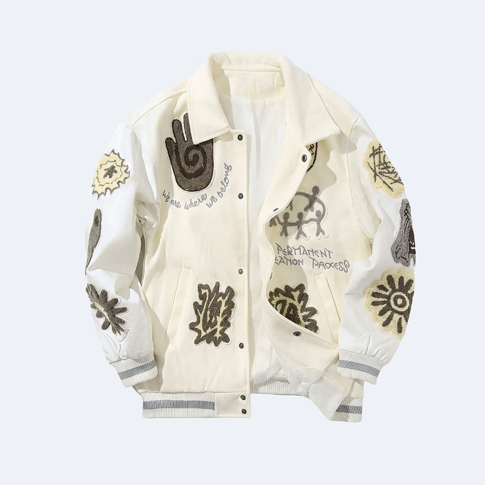 White. An off-white bomber jacket with various graphic patches, embroidered designs, and text on the front and sleeves.