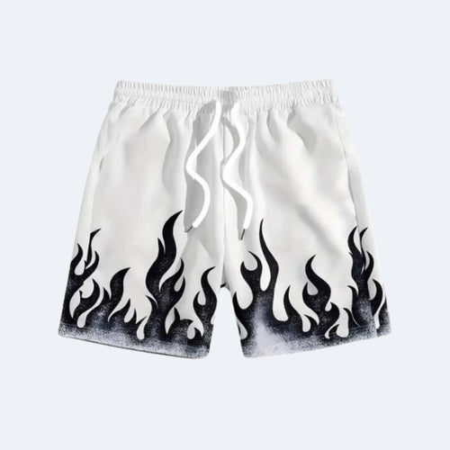 White. White athletic shorts with a black flame print along the bottom hem and a white drawstring.