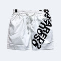 White. White athletic shorts with a black drawstring waist, featuring a large black diagonal text print on the side and black trim details.