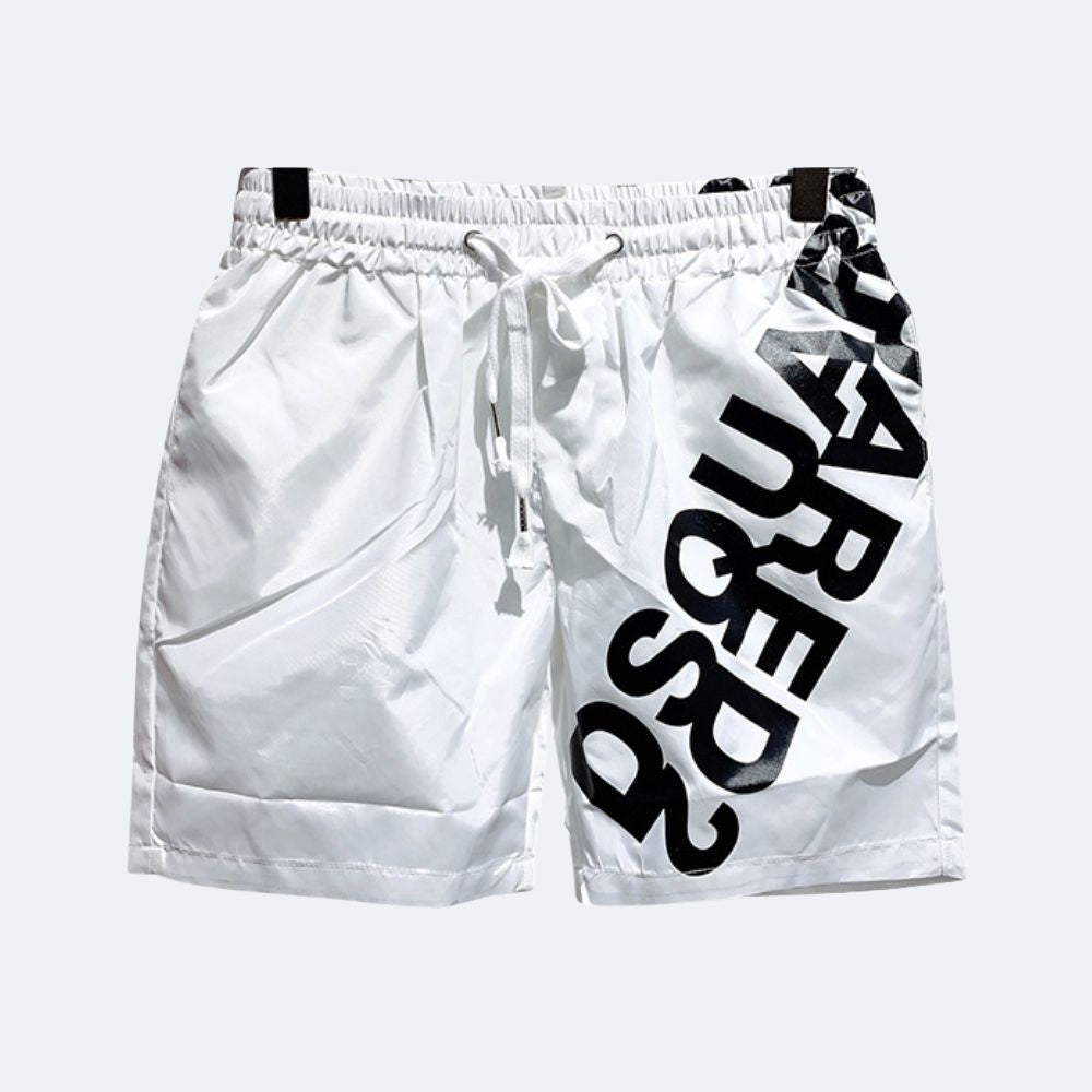 White. White athletic shorts with a black drawstring waist, featuring a large black diagonal text print on the side and black trim details.