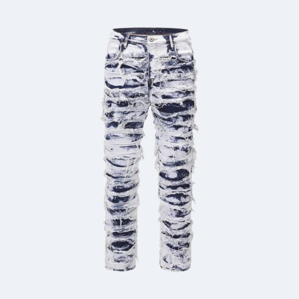 Distressed denim jeans with a white and black marbled pattern and heavy frayed detailing, shown flat against a light gray background.