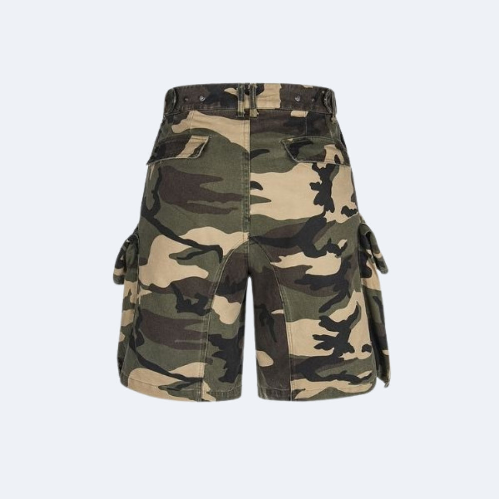 A pair of camouflage cargo shorts with side flap pockets, shown flat against a light gray background.