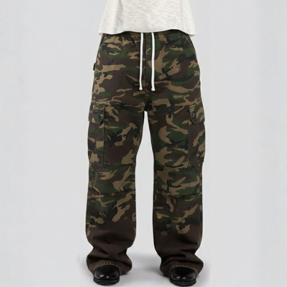 Camouflage pants worn by a person on a white background