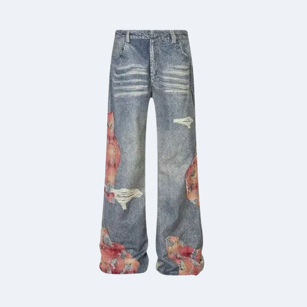 Distressed wide-leg denim jeans in a faded blue wash, featuring ripped details and red floral pattern prints on the lower legs, shown against a light gray background.