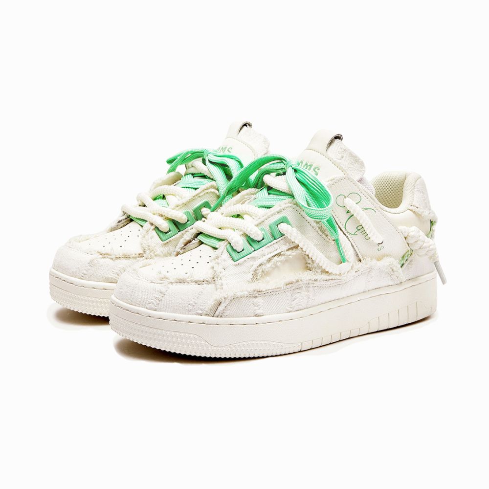 White sneakers with green accents on a white background