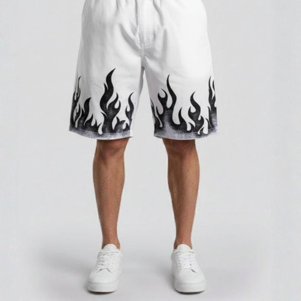 White shorts with black flame patterns worn by a person on a light gray background
