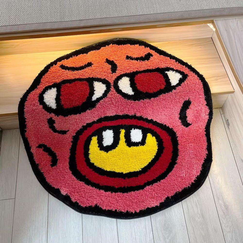 Round colorful rug with a cartoonish face design on a wooden floor.