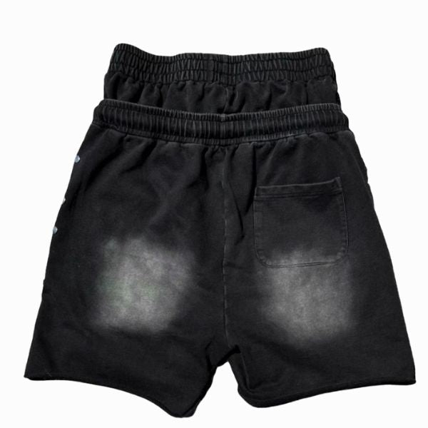 Black shorts with distressed look on a white background