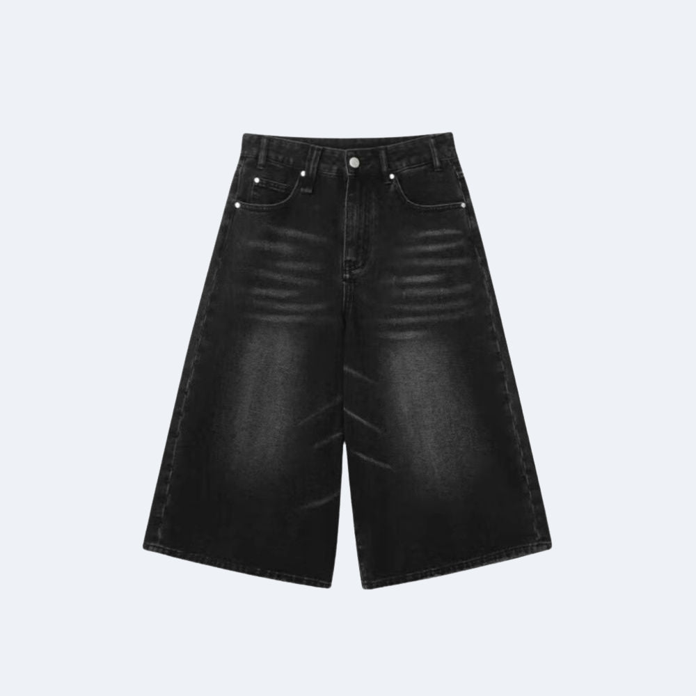 Black wide-leg denim shorts with a faded wash and silver rivets, shown flat on a light gray background.
