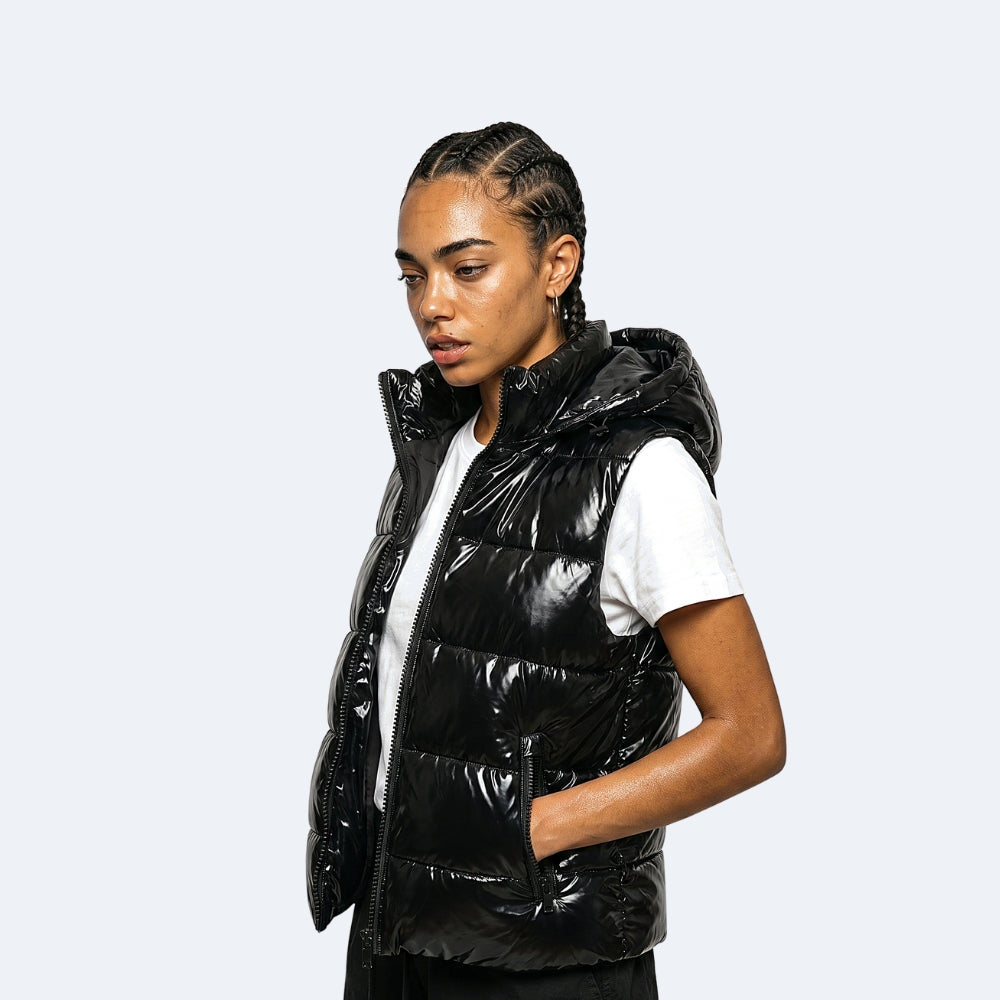 Black. A woman wearing a shiny black puffer vest over a white t-shirt.