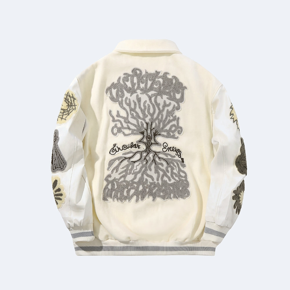 White. Back view of a cream-colored bomber jacket featuring a large gray tree design with the words Infinite Energy across the center, and graphic patches on the sleeves.