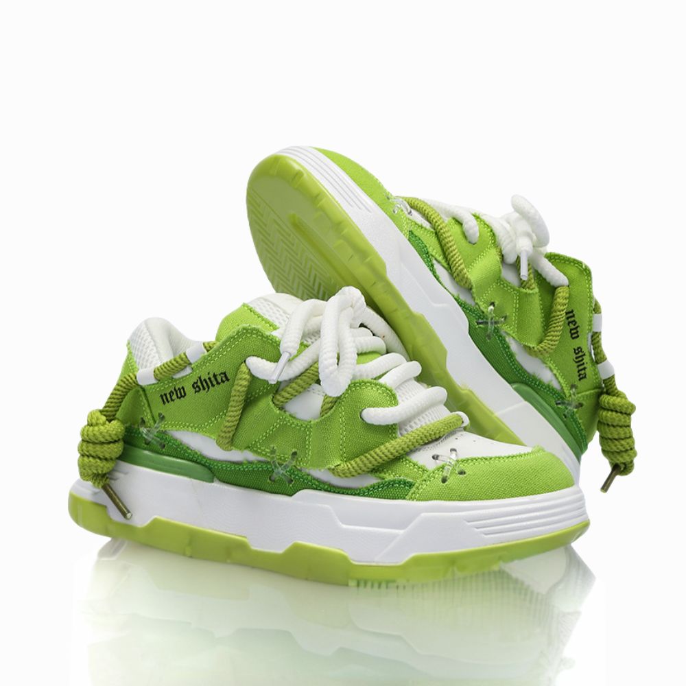 Green and white sneakers with a brand logo on a white background