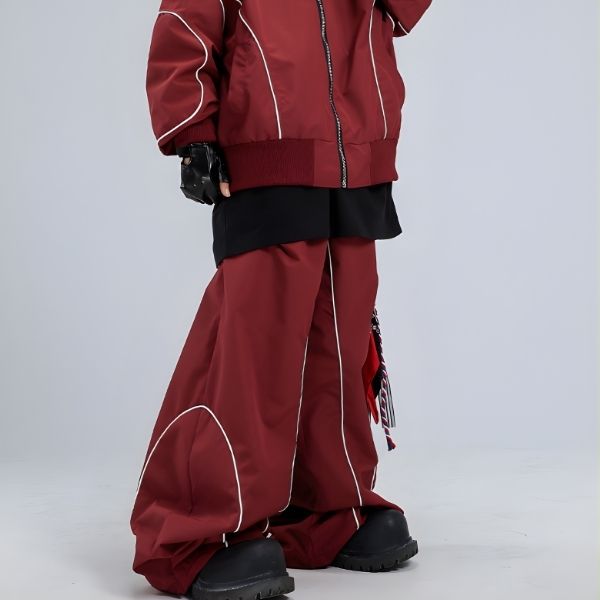 Red outfit with black pants and black shoes on a light gray background