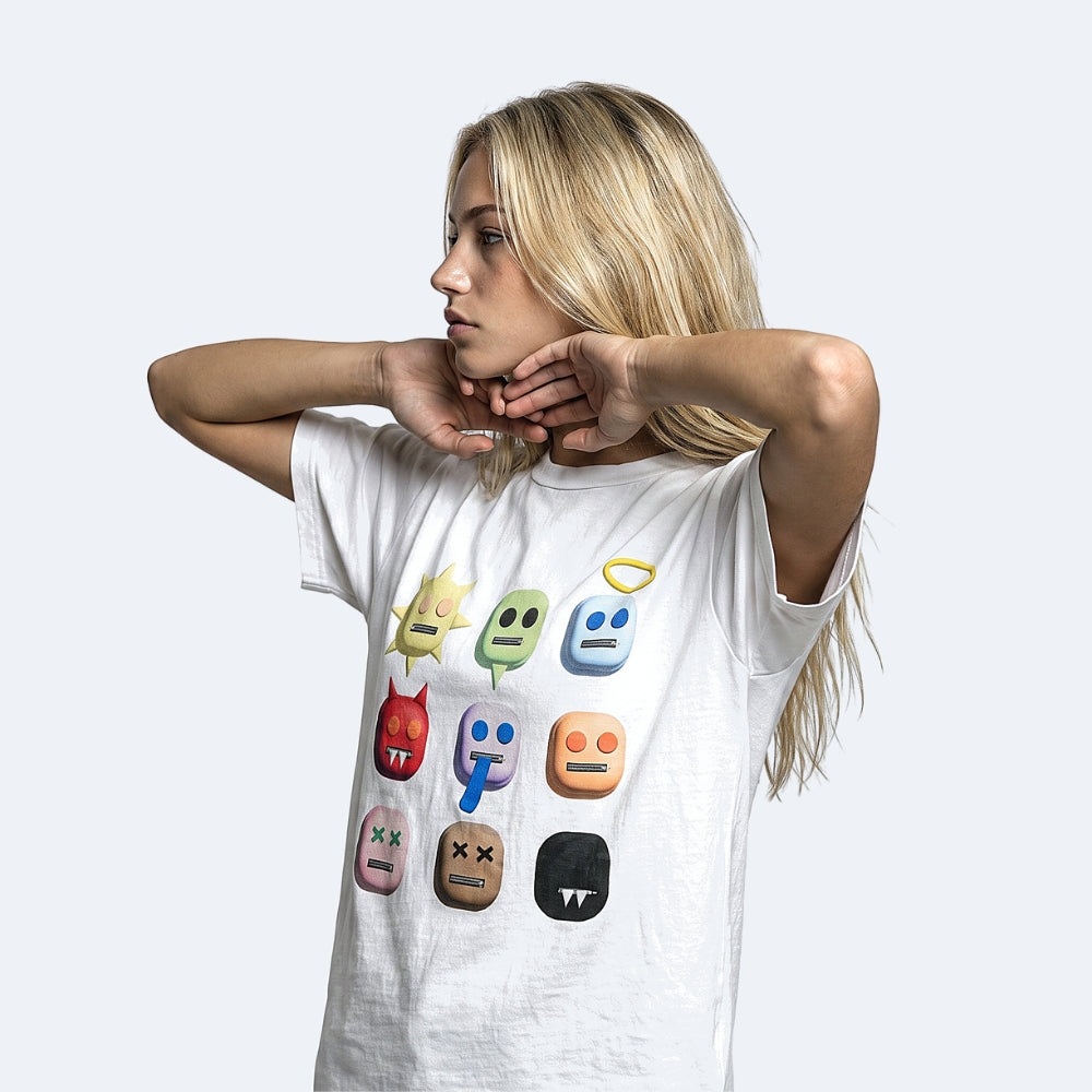 White. A blonde woman wearing a white graphic t-shirt with colorful cartoon emoji faces printed on the front.