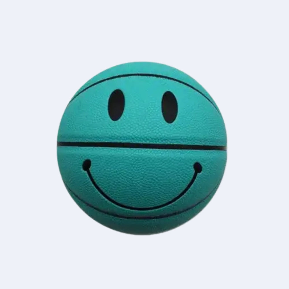 A teal green mini basketball with a black smiley face design, centered on a light gray background.