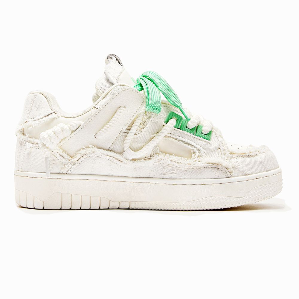 White sneaker with green accents on a white background