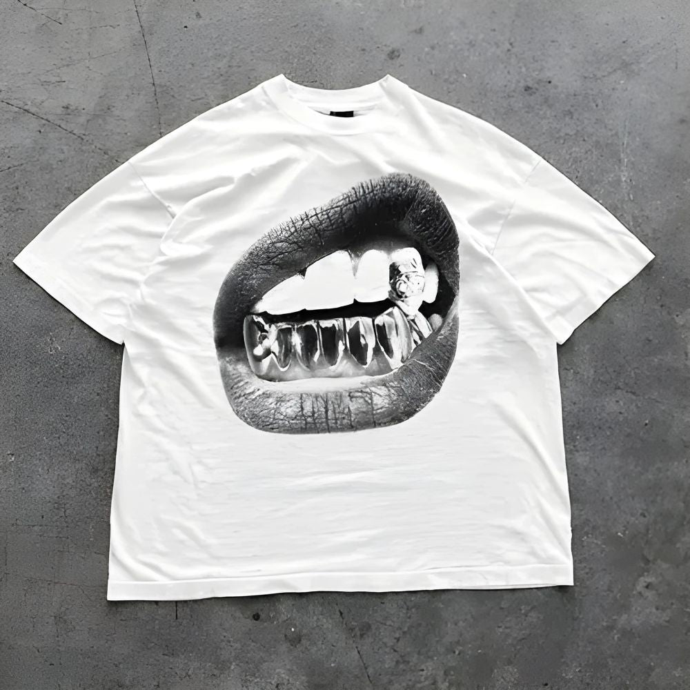 White t-shirt with a graphic of lips and teeth on a gray concrete surface