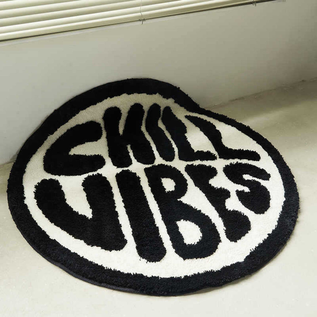 Round black and white rug with 'CHILL VIBES' text on a light-colored floor.
