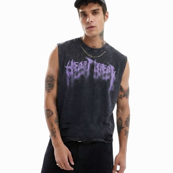 Man wearing a sleeveless black shirt with purple text on a white background