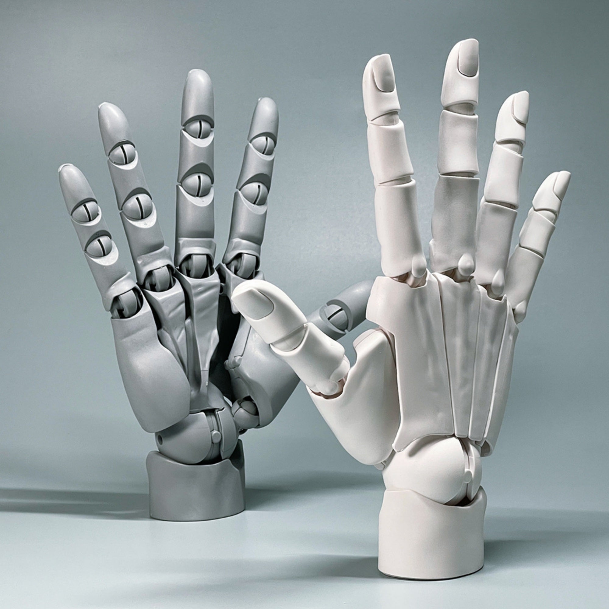 Two robotic hands interacting on a gray background