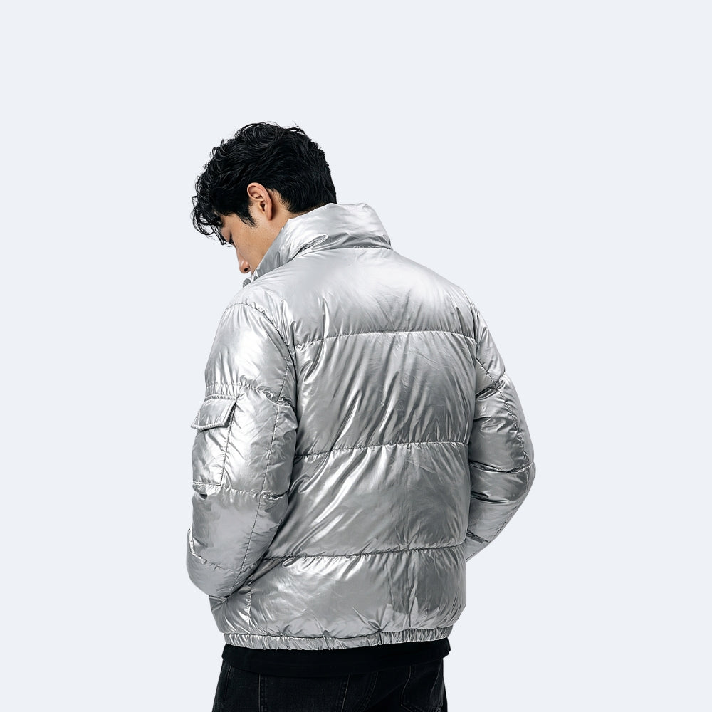 Silver. A man wearing a shiny metallic silver puffer jacket, shown from the back.